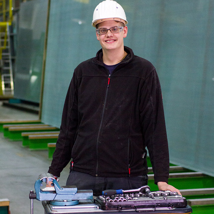 Auszubildender zum Industriemechaniker in der Werkshalle in der Glasindustrie
